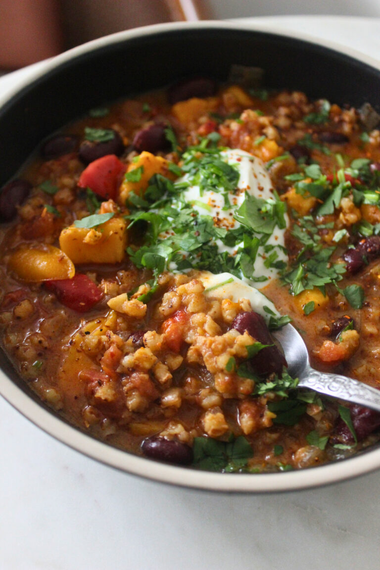 spoonful of Sorghum Sweet Potato Chili topped with tofu sour cream and fresh cilantro